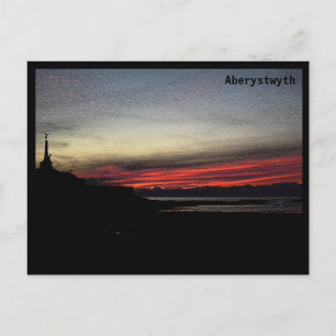 Solnedgång över havet i Aberystwyth-vykortet Vykort