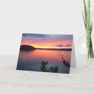 Solnedgång över sjön kort