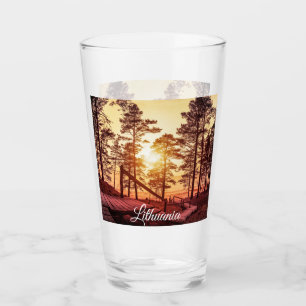 Solnedgång över väg i gräs-skogen glaskopp