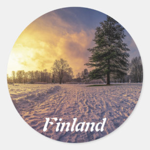 Solnedgång över vinterparken runt klistermärke