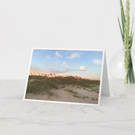 Solnedgång på stranden kort