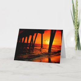 Solnedgång under piren kort