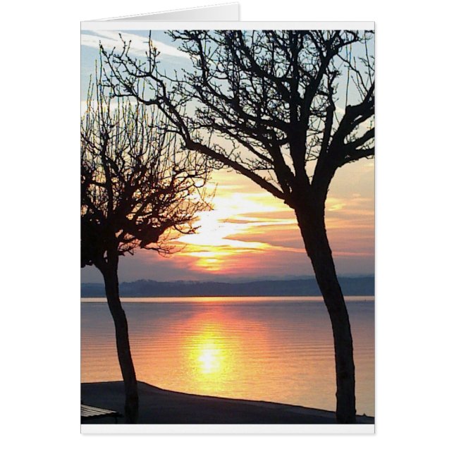 Solnedgång vid sjö hälsningskort (Framsidan)
