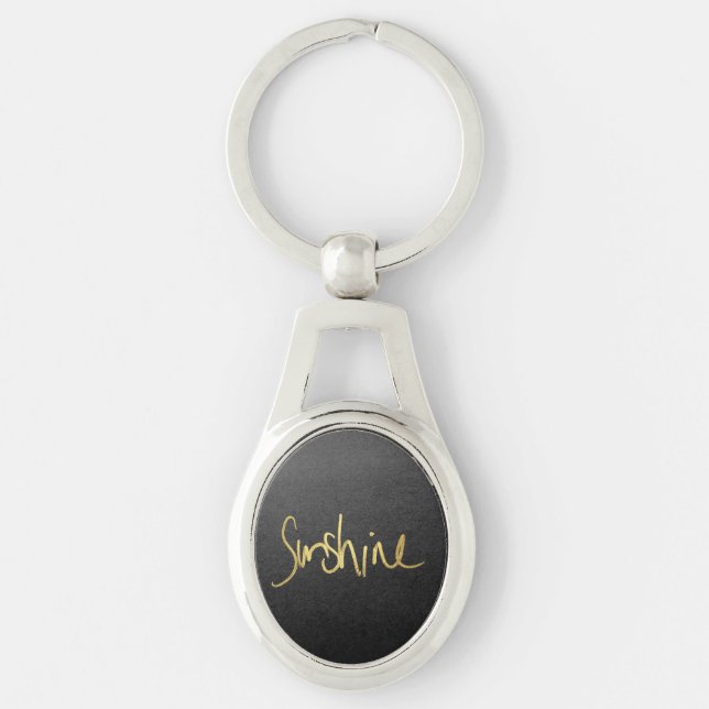"Solsken" typografi i Faux målat guld Ovalt Silverfärgad Nyckelring (Framsidan)