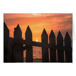 Soluppgång genom ett stängsel hälsningskort