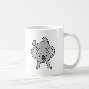 Söt baby koala med ett leende som gör handstående kaffemugg