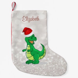 Söt dinosaurie med julhatt, glitterig bokeh liten julstrumpa