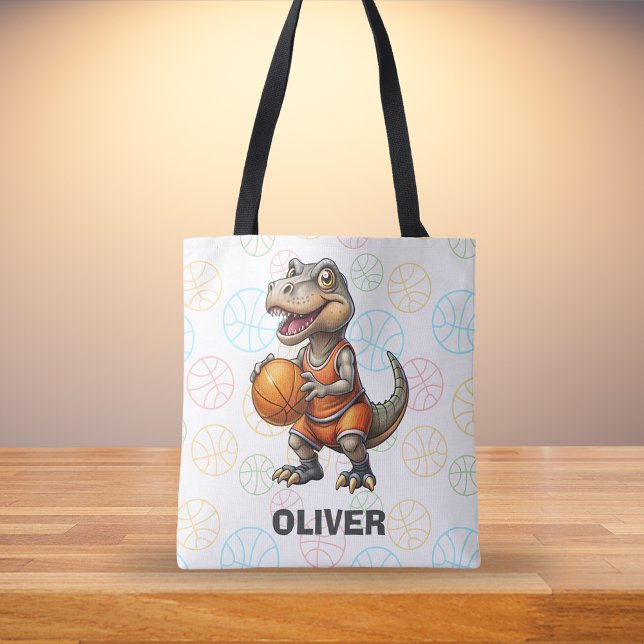 Söt dinosaurie som spelar basket tygkasse (Skapare uppladdad)