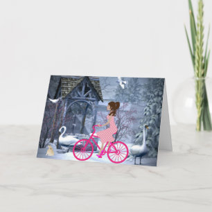 Söt flicka på en rosa cykel vinter kort