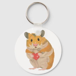 Söt liten hamster som håller ett rött hjärta nyckelring