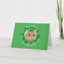 Söt St. Patricksdag-hamster som tittar genom hål