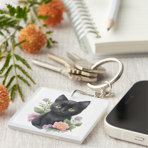 Söt svart katt blomstergalenskap