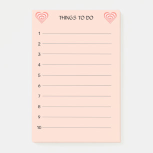Söta korallrosa och vita hjärtan på ljust rosa post-it block