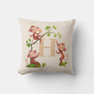 Söta tre apor och gyllene monogram på beige kudde