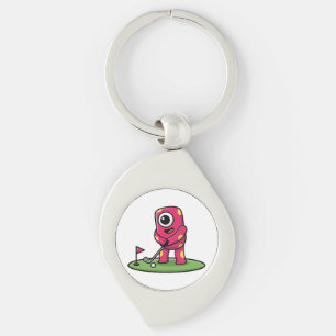 Sött enögd rosa monster som spelar golf-serieteckn swirl silverfärgad nyckelring
