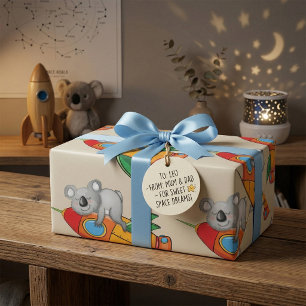 Sovande koala på färgglad raket presentpapper