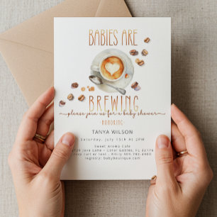 Spädbarn håller på att blåsa två barnskor för kaff inbjudningar