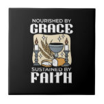 Spiritual Faith and Grace – Uplifting Christian Kakelplatta<br><div class="desc">Celebrate faith with this meaningful 'Nourished by Grace,  Sustained by Faith' design featuring communion elements like a chalice,  bread,  wheat,  and candles. Perfect for Christian gifts,  apparel,  and home decor.</div>