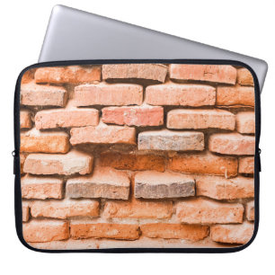 Stäng gammal tegelväggbakgrund och struktur. laptop fodral
