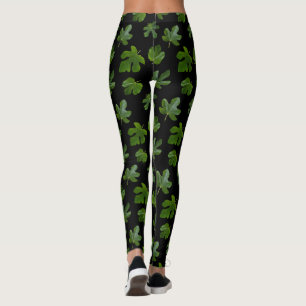 Stängning av grönt löv isolerad på svart bakgrund leggings