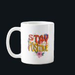 Stay Positive – Floral Motivational  Kaffemugg<br><div class="desc">Brighten your day with this uplifting design! The bold phrase STAY POSITIVE is highlighted with vibrant colors and surrounded by cheerful floral elements,  making it a perfect reminder to embrace optimism and good vibes. Ideal for casual wear,  workouts,  or as a thoughtful gift to inspire positivity.</div>