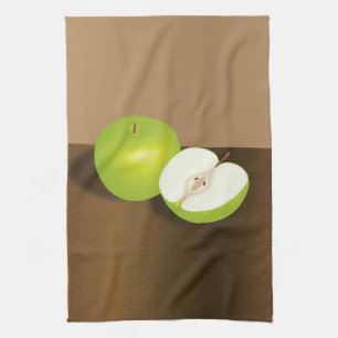 Stilleben med grönt äpple och en halv kökshandduk