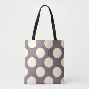 Stora gräddcirklar i polka dots på lila tygkasse