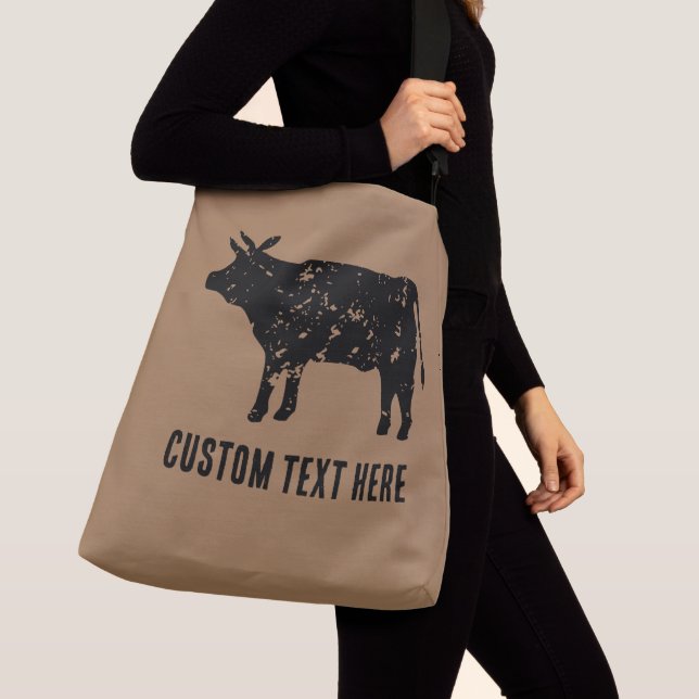 Stort kor-krockkudde med svart silhuett från ko axelväska (Närbild)