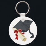 Studentmössa och diplomati nyckelring<br><div class="desc">Svart diplomathatt och diplomatkaval i studenten,  upprullade och säkrade med en röd färgad-band</div>