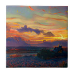 SUNSET KAKELPLATTA<br><div class="desc">En konstform av en vacker solnedgång som även visar sten, strand och en man som fiskar.</div>