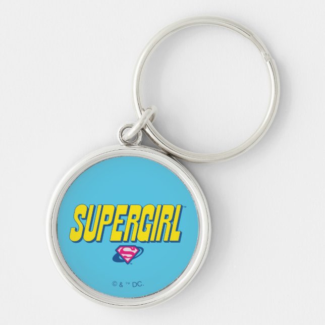 Supergirl Pop-logotyp Rund Silverfärgad Nyckelring (Framsidan)