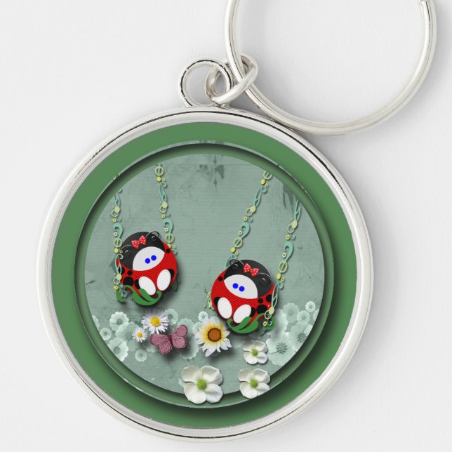 Svängande roligt rund silverfärgad nyckelring (Framsidan)