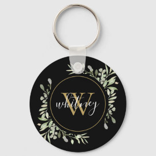 Svart elegant skript med gyllene monogram och grön nyckelring