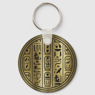 Svart hieroglyphsmönster på forntida guld nyckelring
