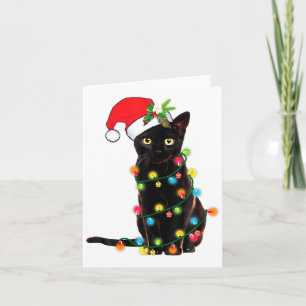 Svart katt jultomte intrasslad i julgransbelysning kort