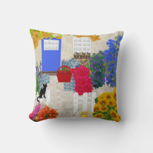 Svart katt och blomsterträdgårdsdyna