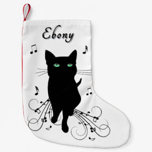 Svart katt omgiven av viskande toner av musik liten julstrumpa