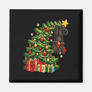 Svart katt som hänger från julgran festlig husdjur magnet