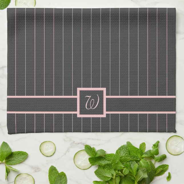 Svart kökshandduk med rosa randmönster (Vikta)