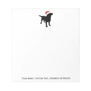 Svart lab hund som ha på sig jultomtenjulhatten anteckningsblock