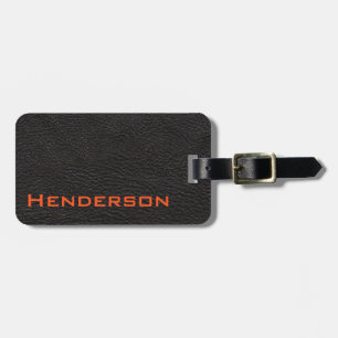 Svart läder med orange text bagagebricka