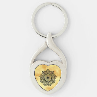 Svart mandala på mjuk guldbakgrund twisted heart silverfärgad nyckelring