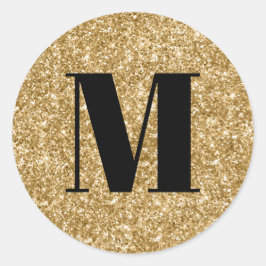 Svart monogram på falskt guldglitter runt klistermärke
