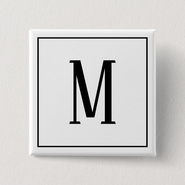 Svart monogram på vit fyrkantig knapp (Framsida)