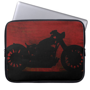 Svart motorcykel på röd bak laptop fodral