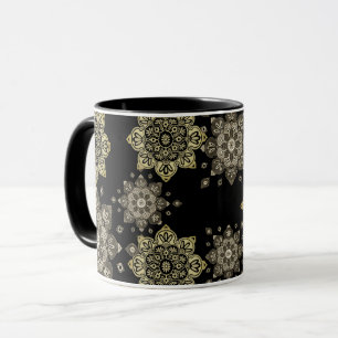 Svart mugg med gyllene medaljonger