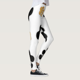 Svart och tan hundvalp avtryck vit leggings