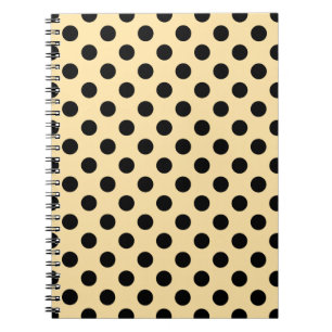 Svart polka dots på blekens gult anteckningsbok med spiral