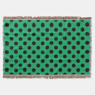Svart polka dots på färsk grönt filt