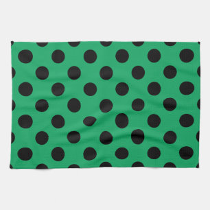 Svart polka dots på färsk grönt kökshandduk